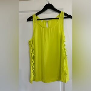 NWOT pretty top with round neck, sleeveless and cris-cross sides